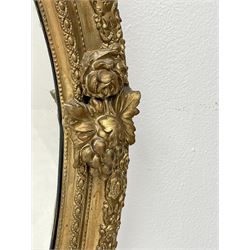 Victorian giltwood and gesso oval girandole mirror, floral cartouche pediment with scrolled leafage, egg and dart decorated frame and slip, decorative rose and berry mounts, with three candle sconces