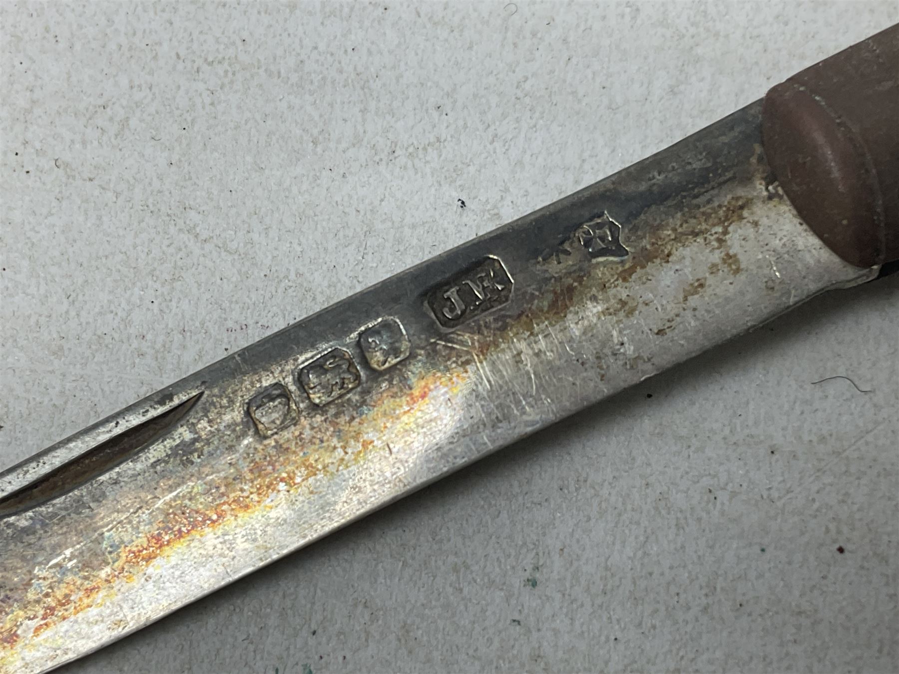 Silver mounted dressing table mirror, embossed with birds, masks, and foliate and C scrolls, hallmarked Birmingham, and fruit knife with mother of pearl handle and silver blade, (2)