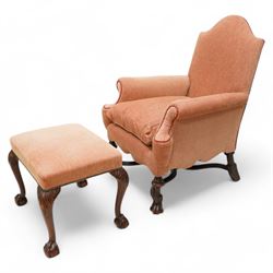 William & Mary design walnut framed armchair, arched cresting rail over rolled arms and C-scrolled arm supports, upholstered in peach herringbone fabric with contrasting rouge twist piping, on turned front feet with scrolled terminals, united by shaped and moulded X-frame stretchers with turned finial (W80cm, H106cm, D80cm); together with a Georgian design mahogany footstool, in matching upholstery with stud band, on acanthus leaf carved cabriole supports with ball and claw feet (60cm x 47cm, H47cm)