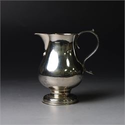 George II silver cream jug, of plain bellied form with capped scroll handle and sparrow be...