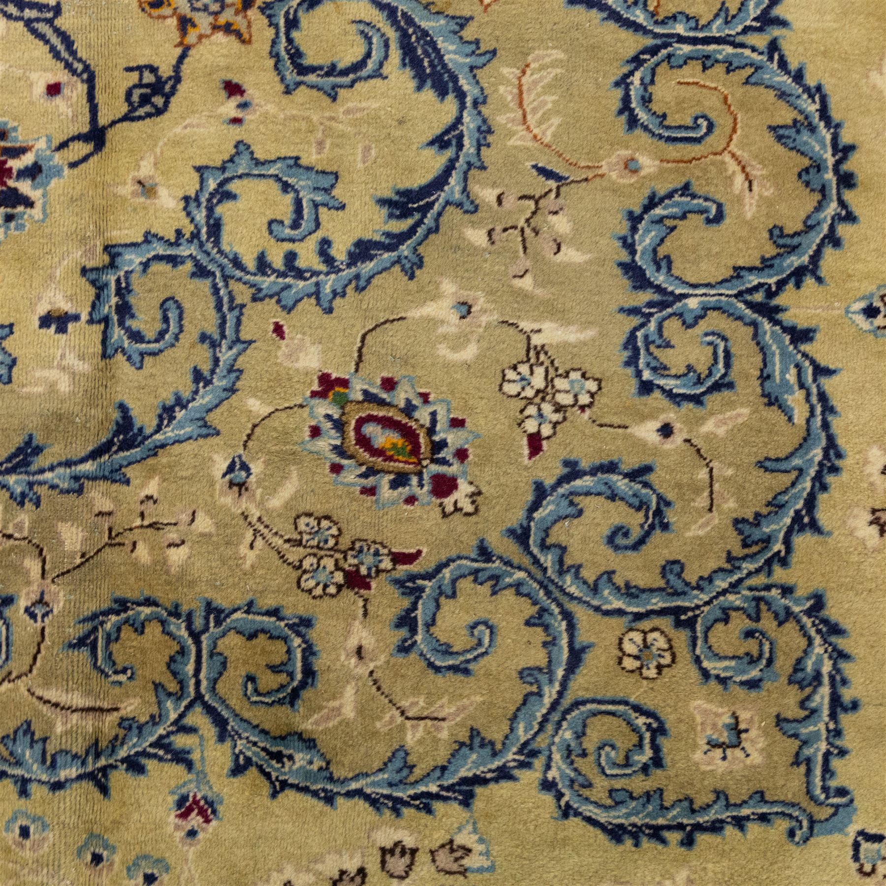 Central Persian Kashan hand-knotted carpet, ivory field with central shaped medallion, surrounded by intricate arrangement of scrolling vine and floral motifs in  pale blue tones, within conforming spandrels and matching border, cotton fringe ends  