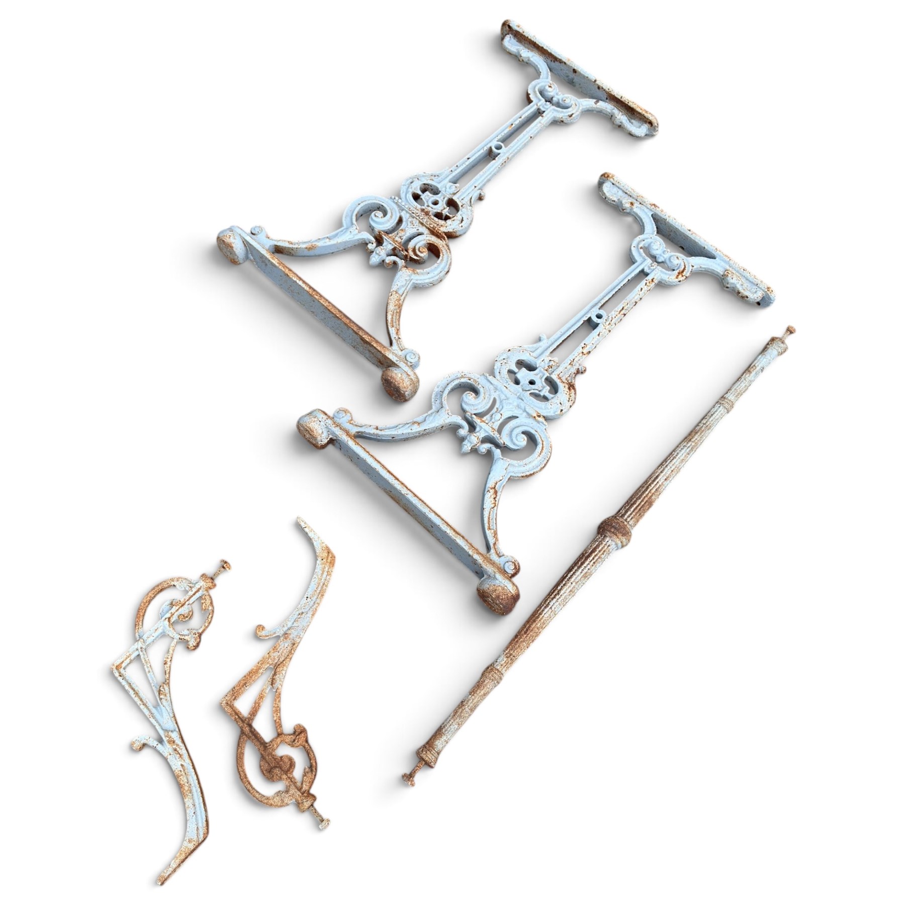 Assorted garden and architectural salvage, comprising a galvanised watering can, two long-handled cutting tools, metal pole, pair of ornate cast iron supports and further decorative fragments