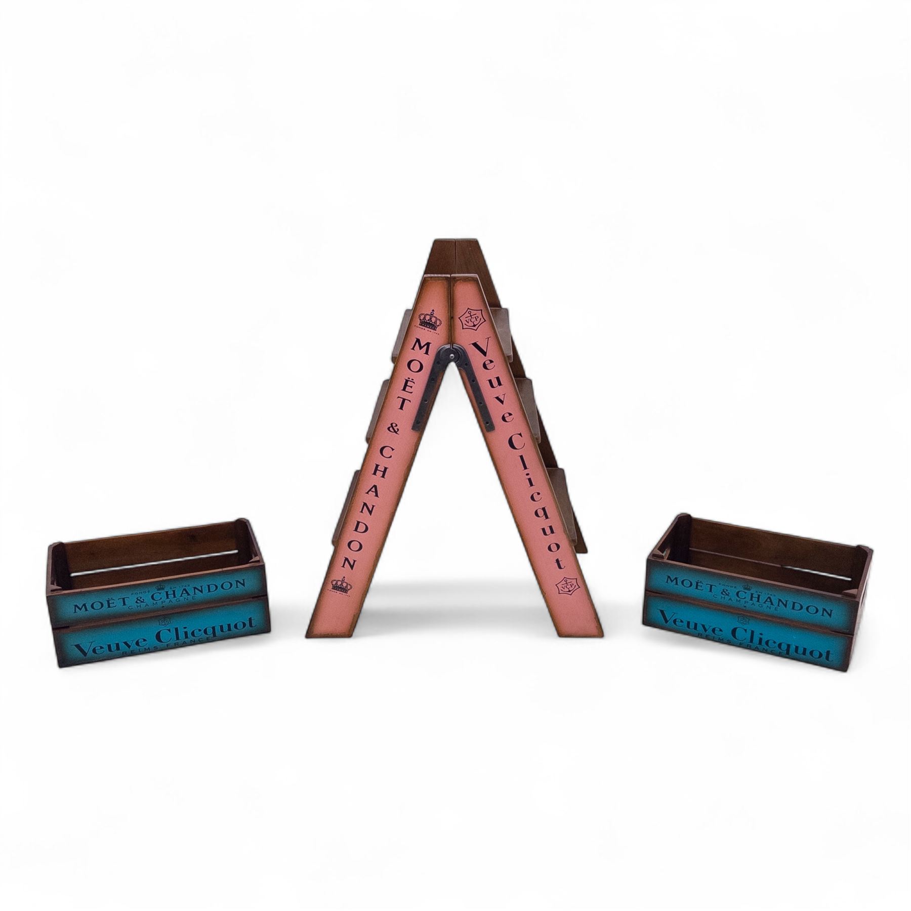 Three-piece champagne advertising display set, comprising pine steps with painted Dom Pérignon and Bollinger lettering, and two wooden boxes branded Moët & Chandon and Veuve Clicquot (Steps H 80cm, W 44cm, D 68cm, crates each H 18cm, W 44cm, D 26cm)