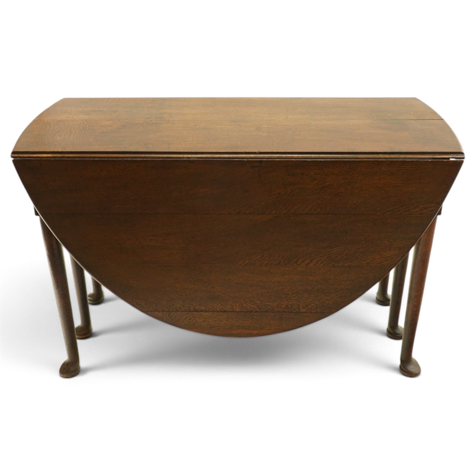 George III oak six-legged drop-leaf dining table, the oval drop-leaf top over six gate-leg supports with pad feet