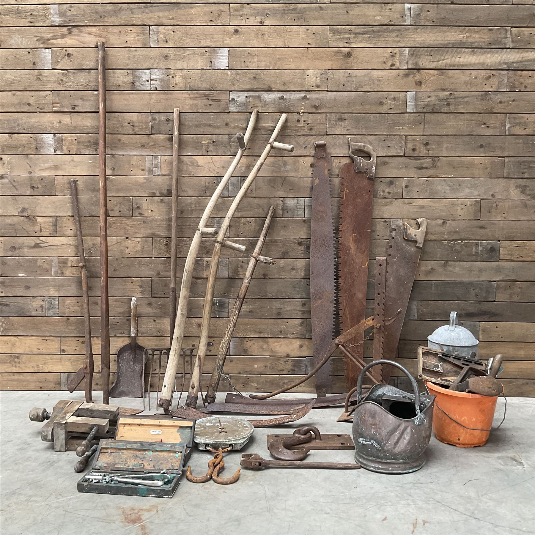 Large quantity of vintage hand tools including scales, scythes, saws etc