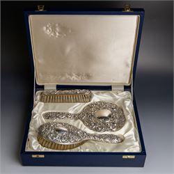 Silver mounted three piece dressing table set, comprising hand mirror, hairbrush and cloth...