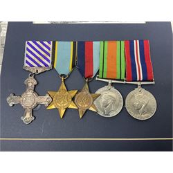 Warrant Officer Gordon Pearce D.F.C. R.A.F.V.R. - display of five medals comprising copy Distinguished Flying Cross, copy Air Crew Europe Star, 1939-45 Star, 1939-45 War Medal and Defence Medal; framed with RAF cap badge, two copy photographs in uniform and copy of investiture letter; mounted and glazed in pine frame 34 x 66cm