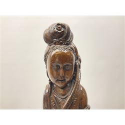 Two large hardwood Oriental figures carved as a man and woman donning robes upon naturalistic plinths