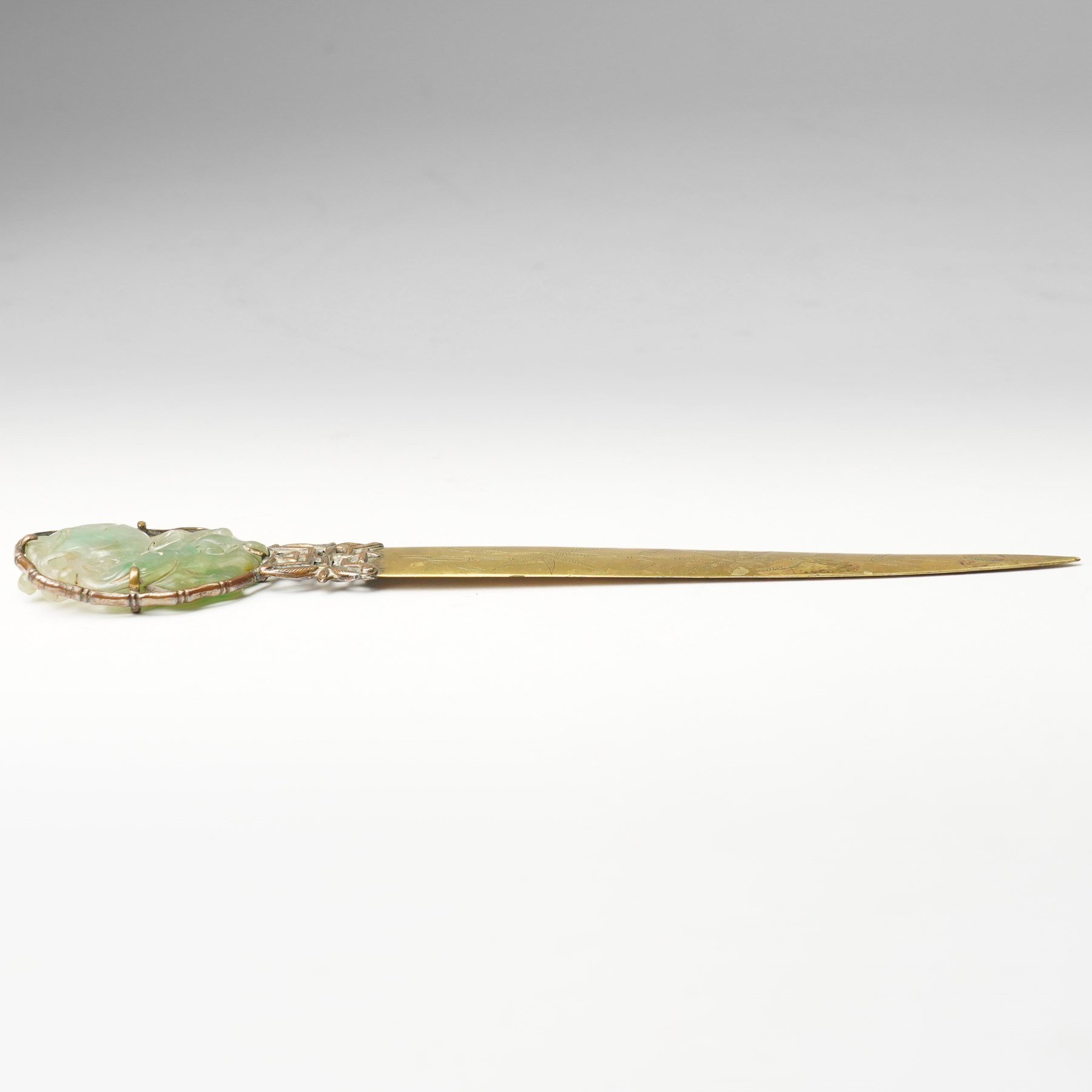 Chinese 18th/ 19th century jade pendant, carved as a peach on a branch, later mounted as a brass paper knife, with bamboo engraved decoration, H20cm