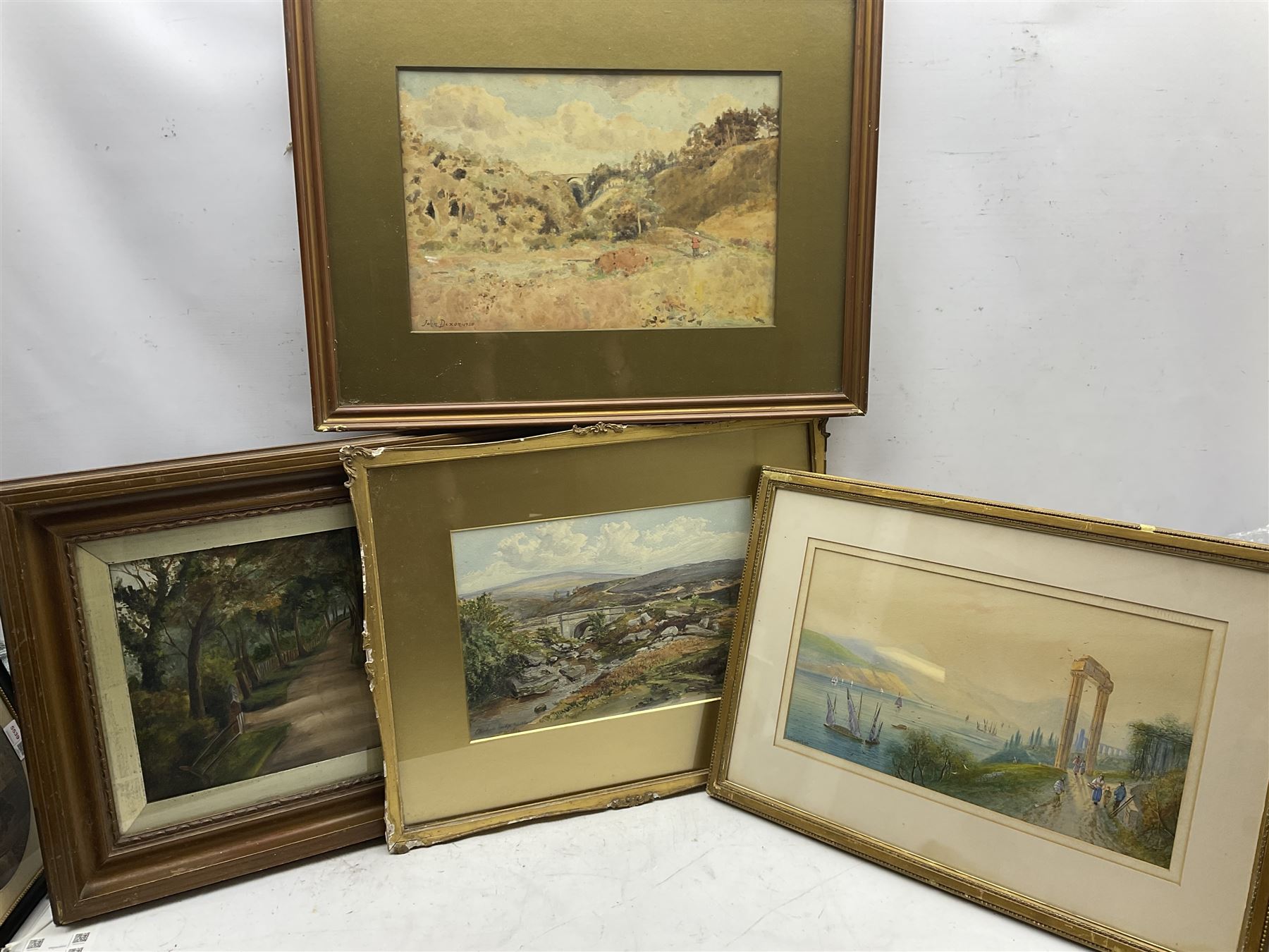 John Dixon (British early 20th century): Rural Landscape with Viaduct, watercolour signed and dated 1920; MW (British 19th century): 'Bridge Goathland', watercolour signed and dated 1862 together with a watercolour of a Mediterranean Coast with Ancient Ruins and a gouache max 26cm x 40cm (4)