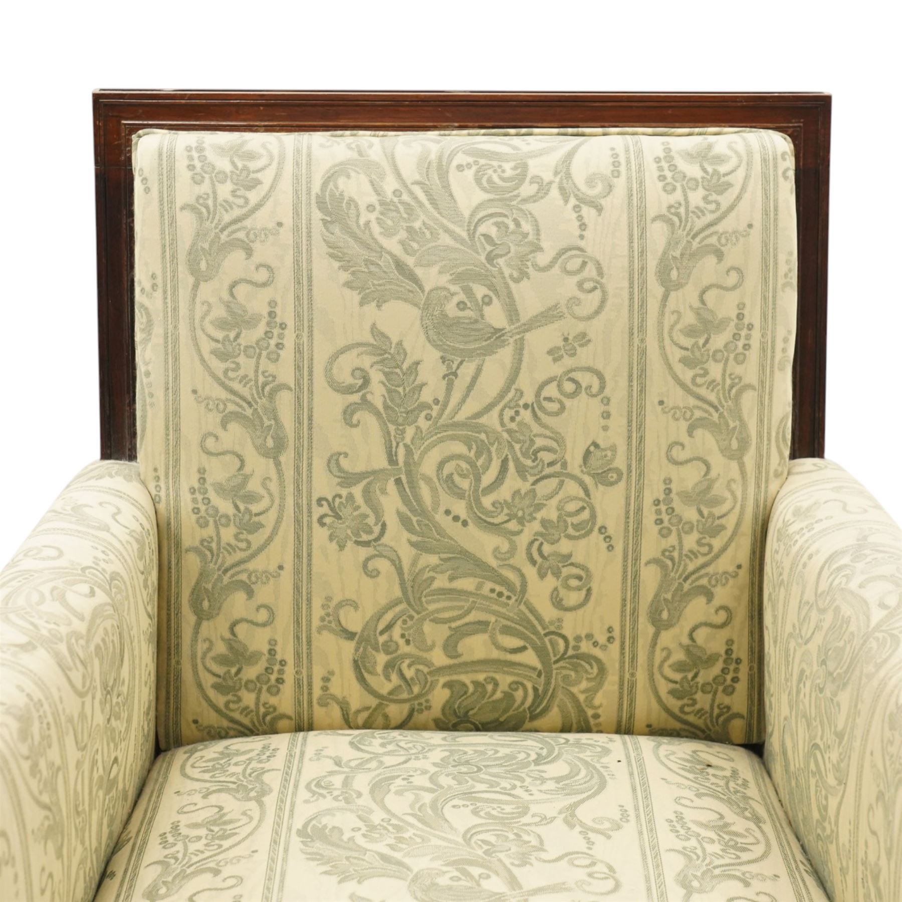 William IV rosewood framed library armchair, squared form with green on ivory ground upholstery, moulded lower seat rail with applied roundels over reeded supports, terminating to brass cups and castors