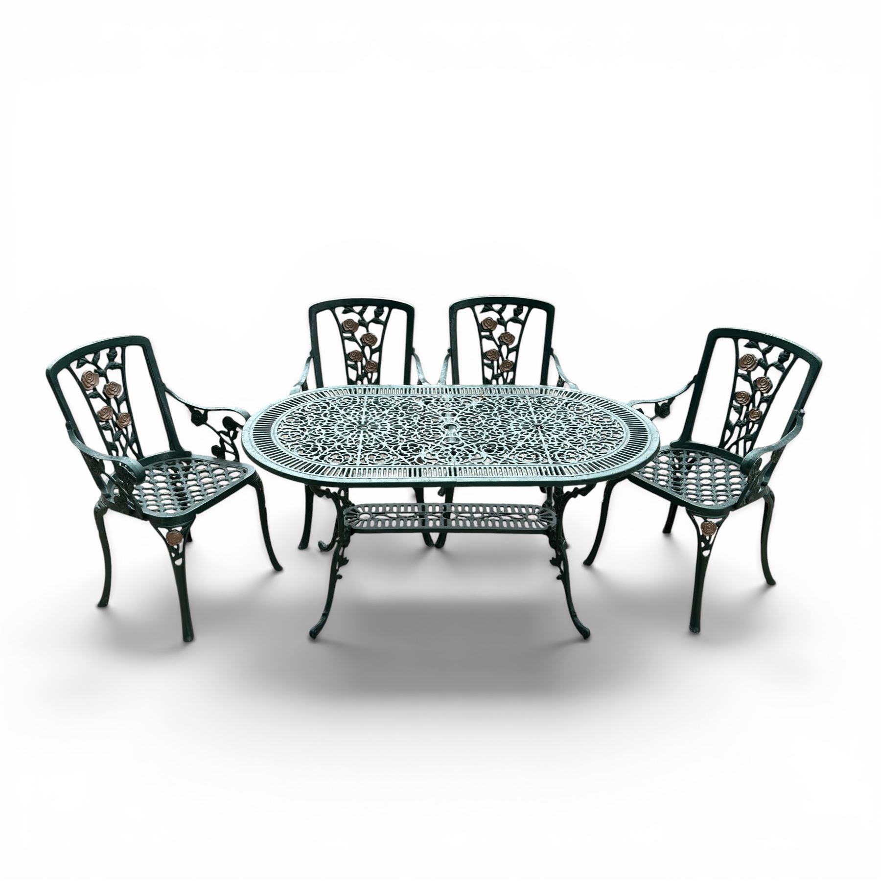 Cast aluminium oval garden table and set of four armchairs with pierced rose design back splats