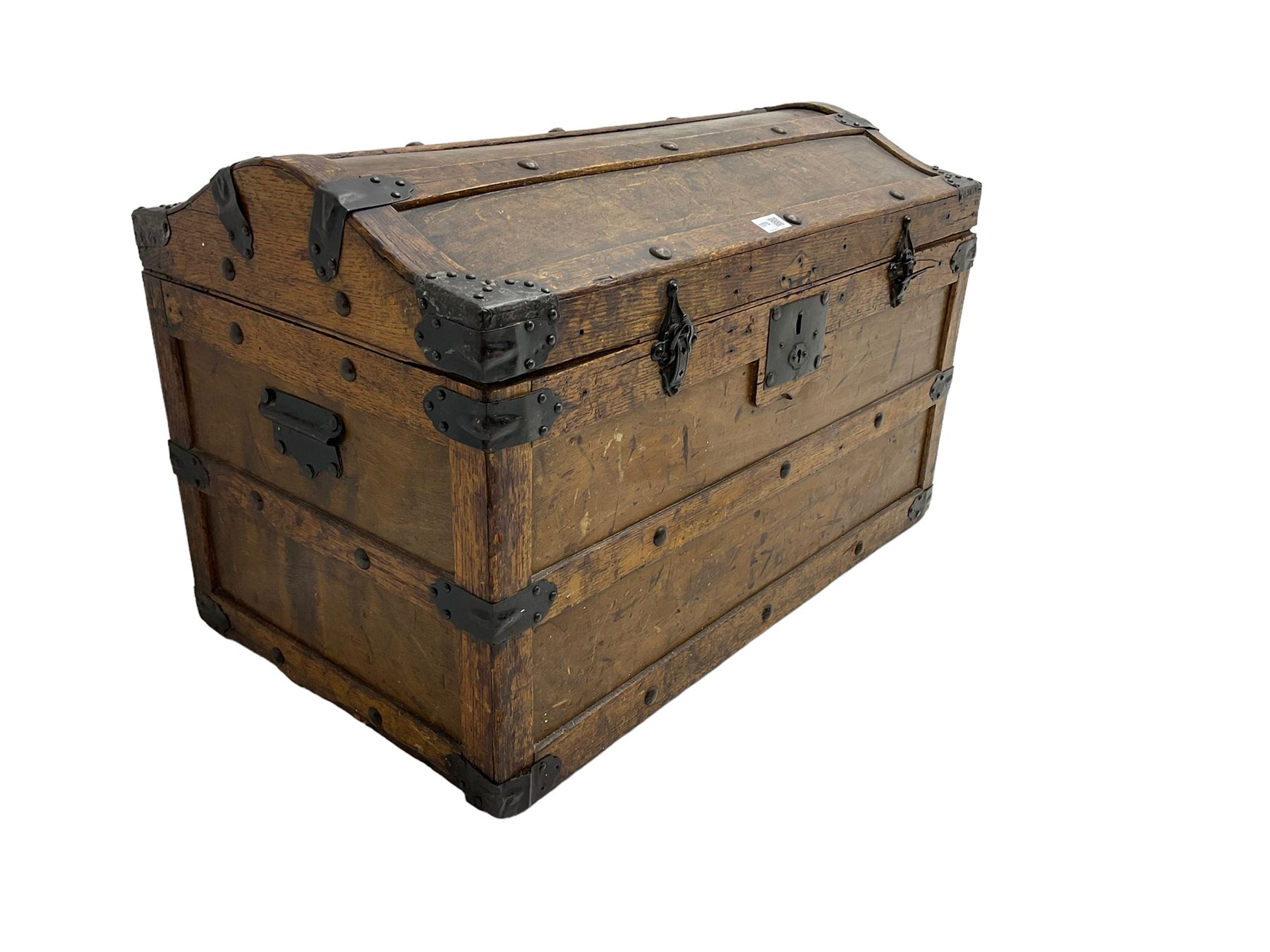 Late 19th to early 20th century oak framed travelling trunk, dome top with iron fittings and panelled sides and top, interior labelled 'The Anchor Patent Waterproof Travelling Trunk - 1902'