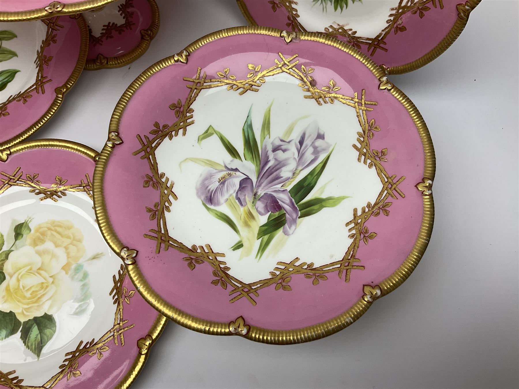 Victorian dessert service, comprising four comports and nine plates, each decorated with floral sprigs to the centre with a pink and gilt border, largest comport H13cm, plate D22.5cm