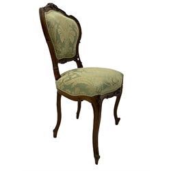 19th century walnut framed chair, the shaped back carved with foliage cartouche, on scrolled carved cabriole supports, upholstered in pale green patterned fabric