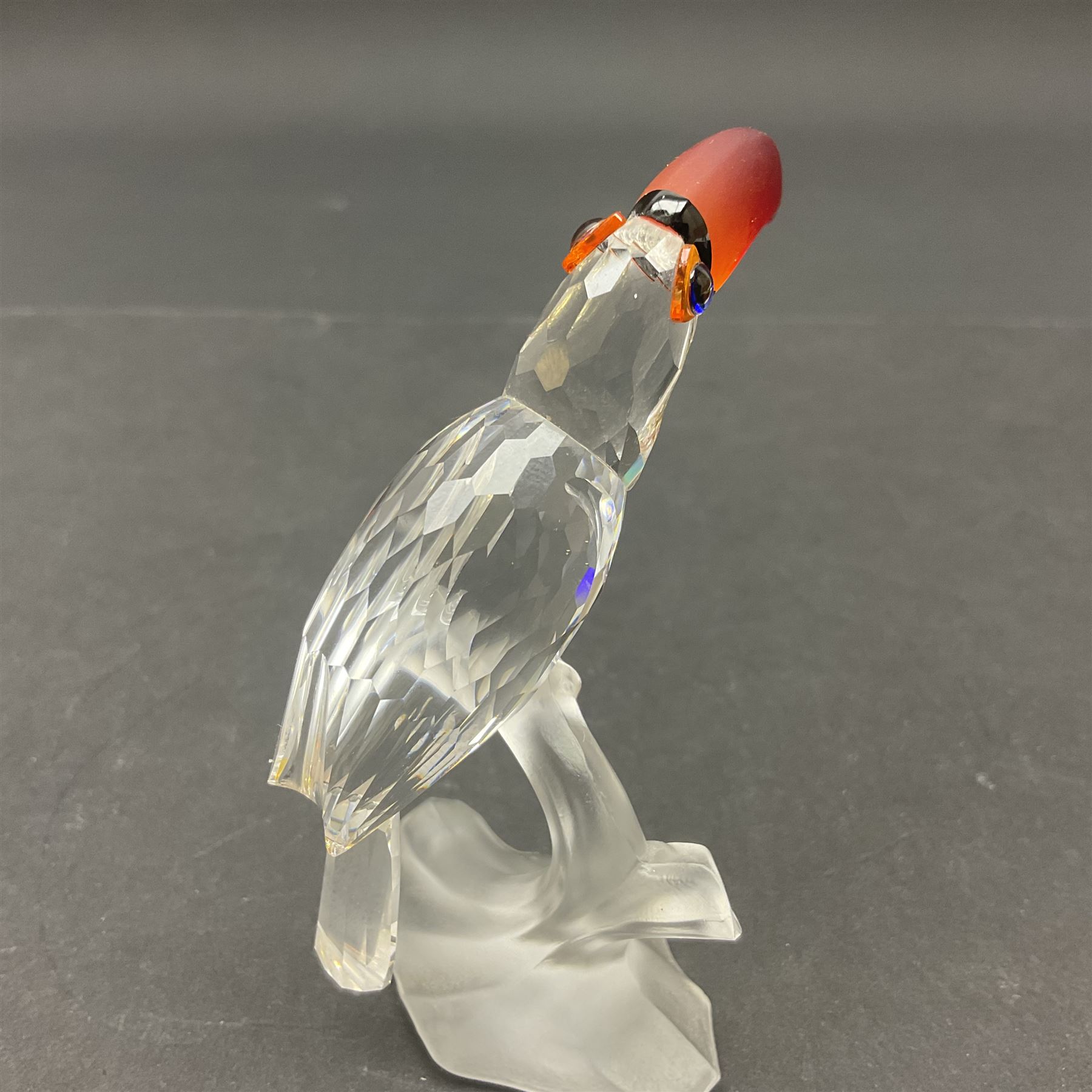 Three Swarovski Crystal bird figures, comprising Toucan, pair of puffins and pair of parrots on a branch, tallest H10cm