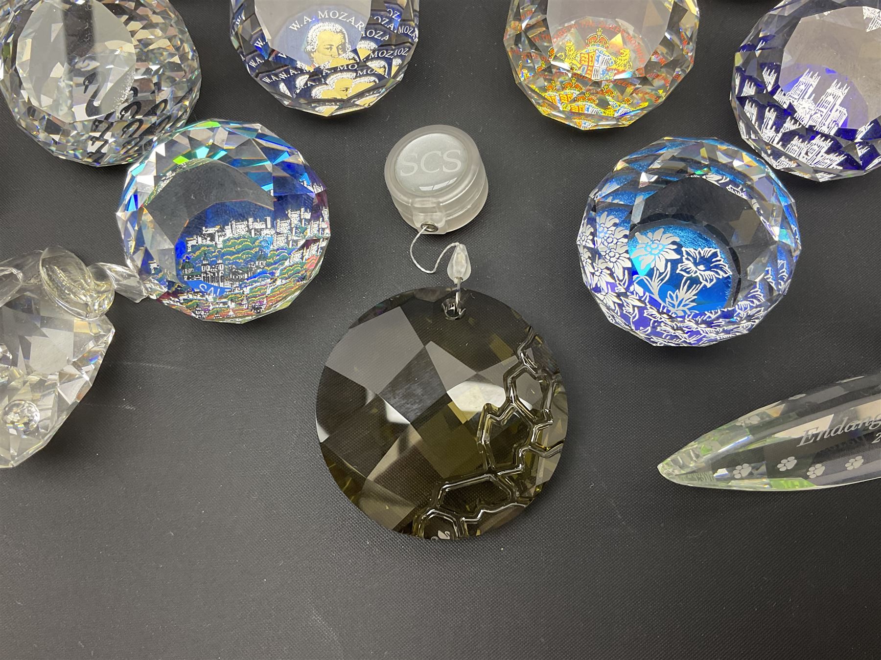 Swarovski Crystal paperweights, to include a globe with dove to the top, pyramid shapes etc, together with a large collection of boxes and stands  