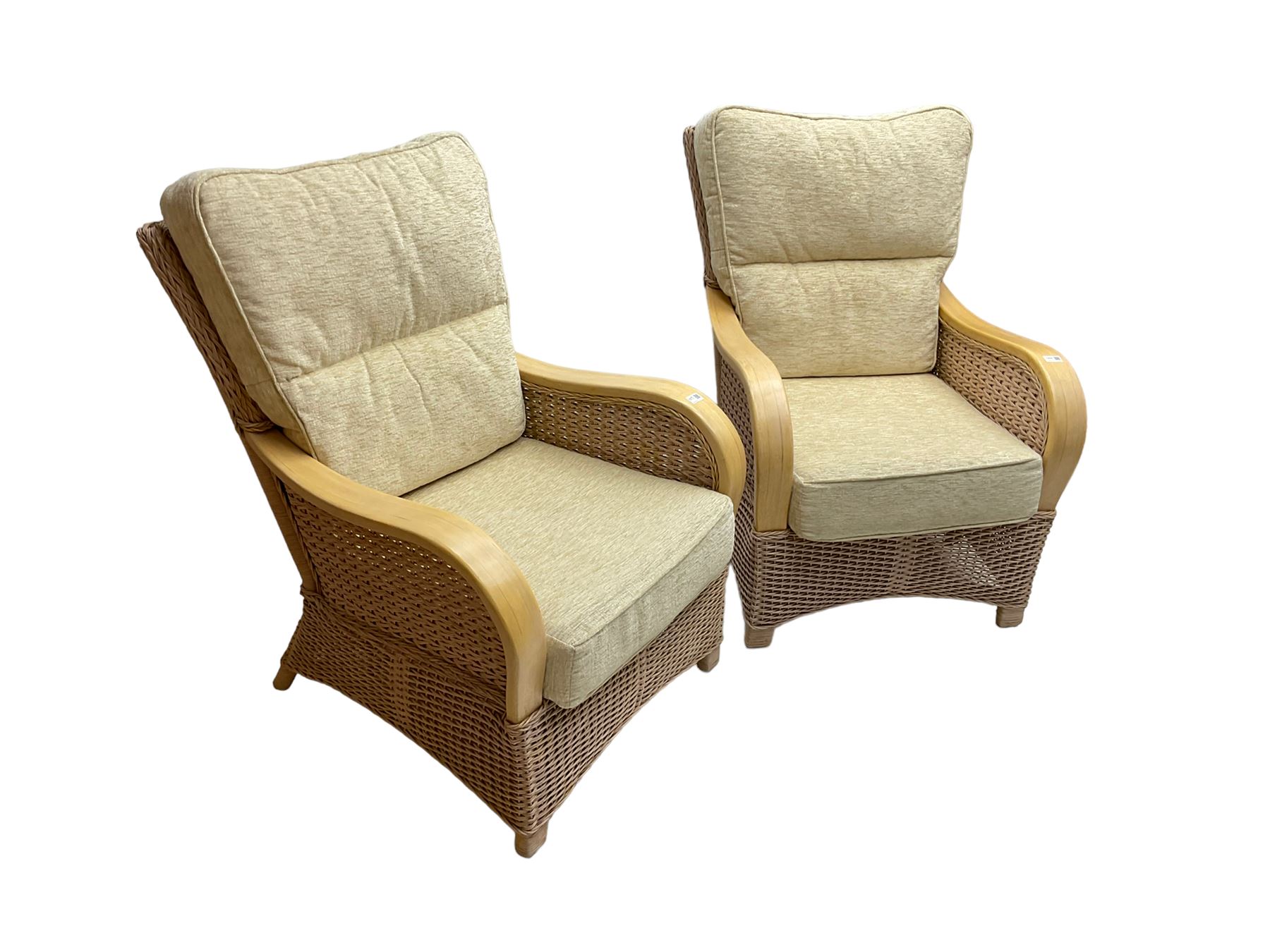 Contemporary rattan conservatory suite - two seat sofa with wicker frame and loose cushions upholstered in textured champagne fabric (W125cm H98cm); pair of matching armchairs (W72cm H98cm); rectangular glass-topped coffee table with rattan frame and undertier (W85cm D60cm H47cm); and matching square side table (W53cm H55cm)