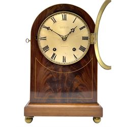 Winterhalder and Hofmeier eight-day striking mantle clock retailed by John Walker, South Molton Street, London “TO HM THE KING”, c 1905, In a round topped figured mahogany veneered case with inlaid satinwood stringing, on a concave moulded plinth raised on four bun feet, with a silvered dial, short Roman numerals, minute track and matching pierced steel hands within a brass bezel and convex glass, going barrel movement with a recoil anchor escapement striking the hours and half hours on a coiled gong.



