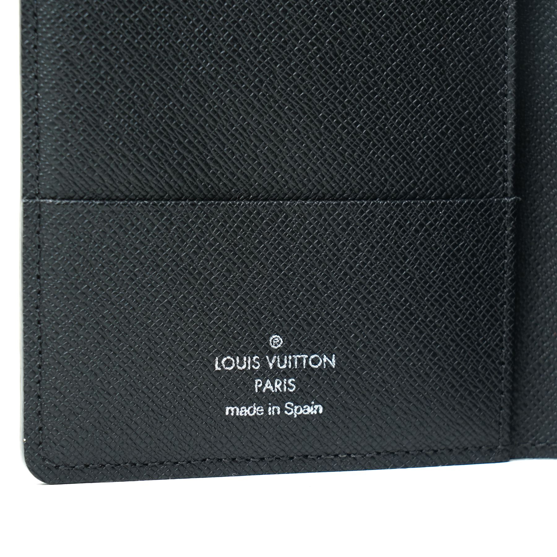 Louis Vuitton Damier Graphite canvas passport holder, the black and grey checkerboard exterior opening to a crossgrain leather interior with card slots and slip pockets, stamped Louis Vuitton Paris and made in Spain, together with original Louis Vuitton box and dust cloth