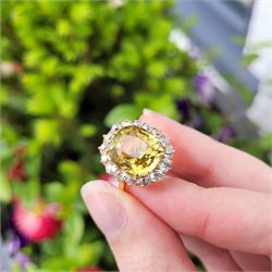 Early 20th century gold chrysoberyl and diamond cluster ring, single cushion cut yellow / green chrysoberyl of approx 8.00 carat, surrounded by sixteen old cut diamonds, stamped 18ct, total diamond weight approx 1.10 carat
