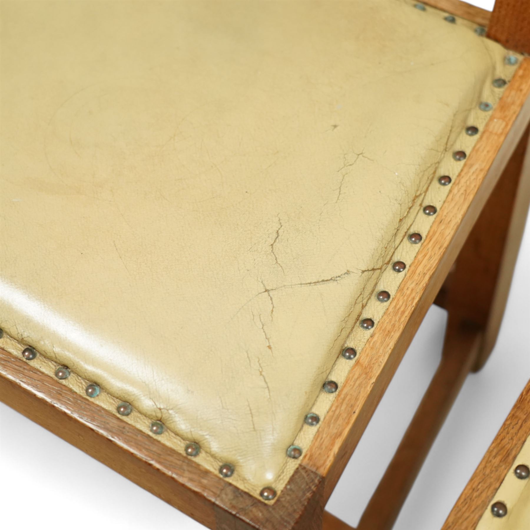 Mouseman - set of eight (7 + 1) oak dining chairs, pierced and carved lattice back over leather upholstered seat, on octagonal front supports united by stretchers, carved with mouse signature, by the workshop of Robert Thompson, Kilburn