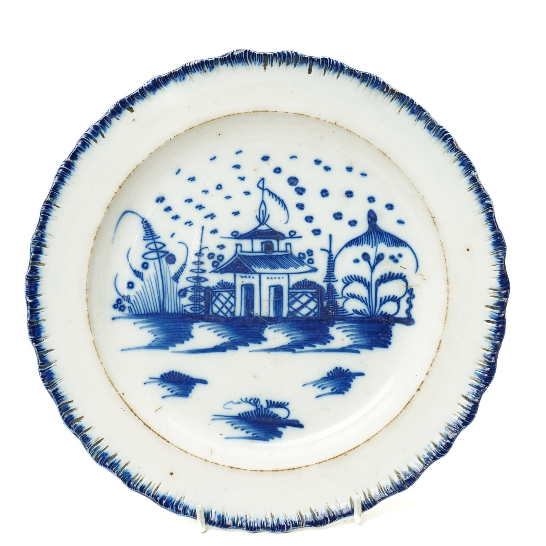 18th century creamware plate, painted with a chinoiserie landscape, D25cm; together with a Wedgwood terracotta jug, stamped to base, H15cm, and a Wedgwood Capri ware coffee pot, stamped to base, H19cm (3)