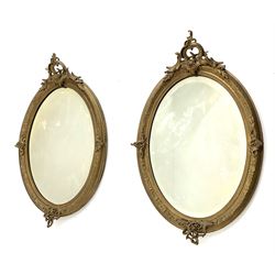 Pair 19th century gilt wood oval pier glass mirrors, the pediment set with ornate scroll and foliage cartouche. moulded frame, bevelled glass plates