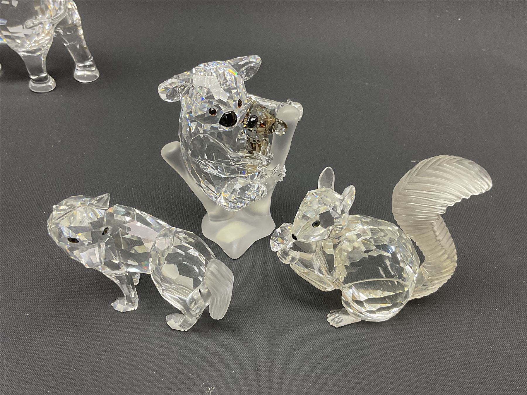 Twenty nine Swarovski Crystal animals, to include koala and baby, in frosted tree branch, elephants, polar bears, squirrel, monkeys, panda, unicorn and snails, etc 