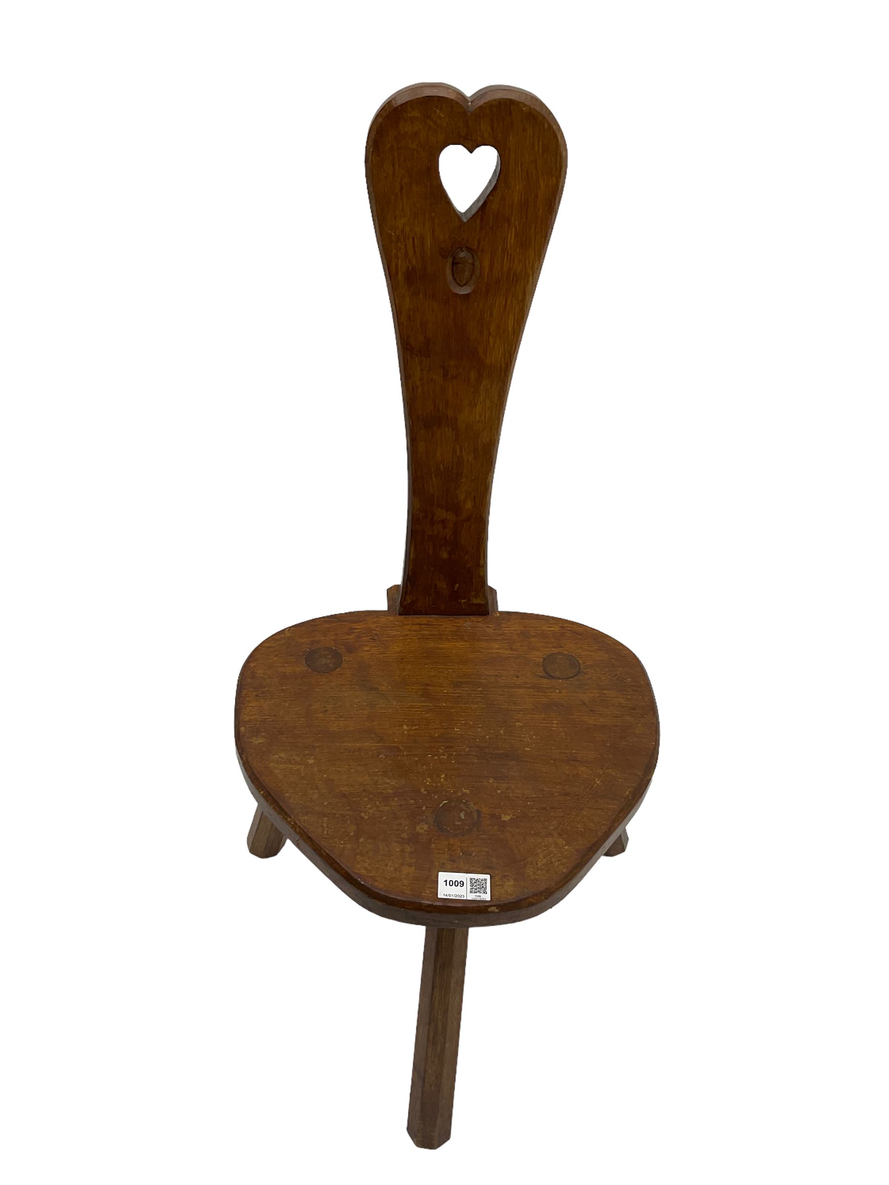 Acornman - adzed oak spinning chair, spoon shaped back with pierced heart and acorn signature, spade-shaped seat raised on octagonal tapering supports by Alan Grainger of Brandsby