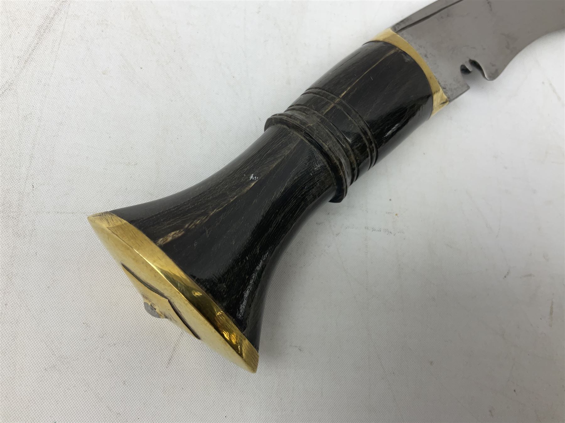 Ceremonial kukri, the 28.5cm curving blade inscribed 'O RDEP NEPAL 9/81' with brass mounted horn grip; in gloss black scabbard with two skinning knives 41cm overall