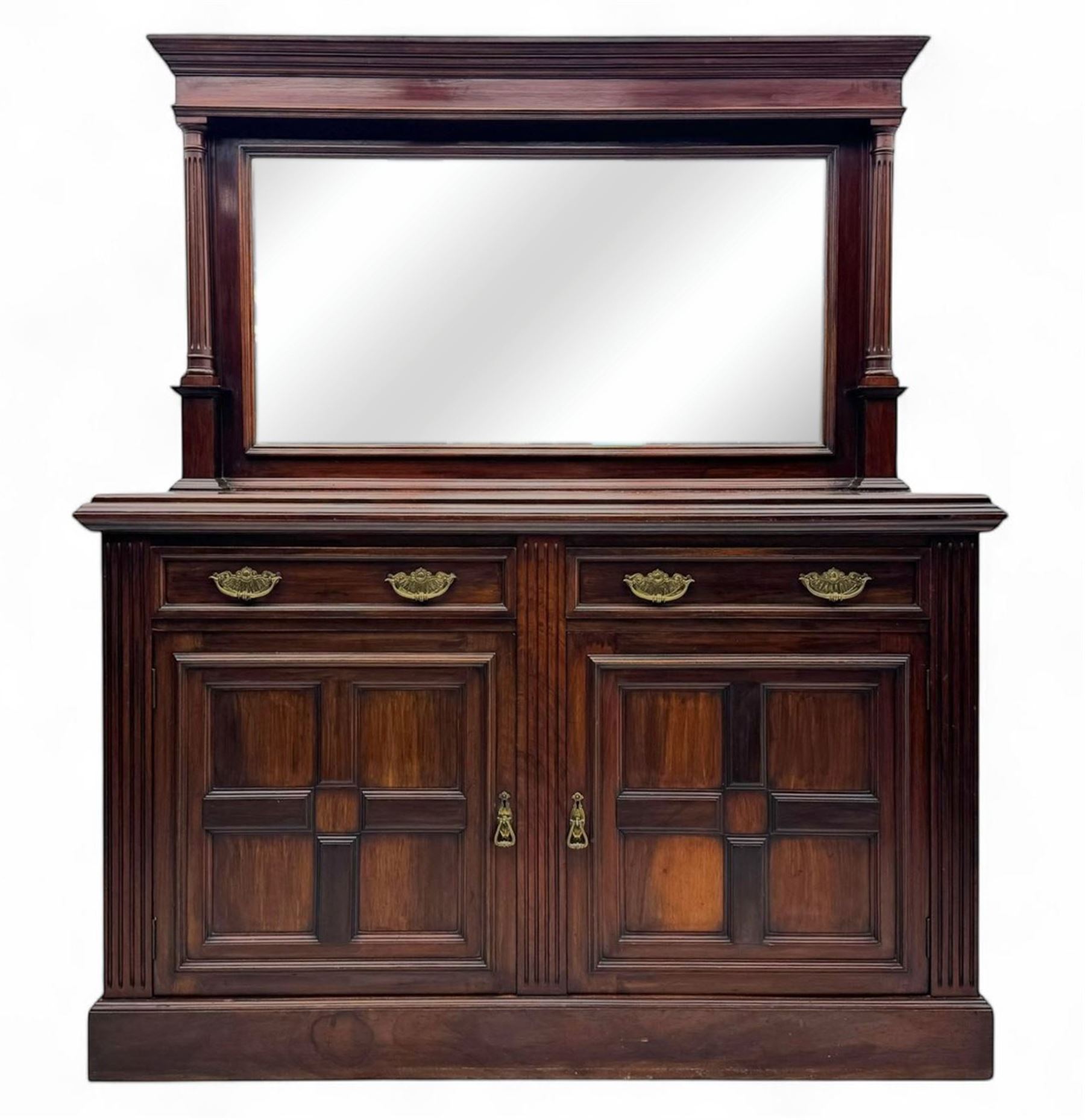 Victorian mirror back press, the arched corniced mirror back flanked by half columns, the base fitted with three drawers and four moulded panel doors with geometric detail, on a block plinth