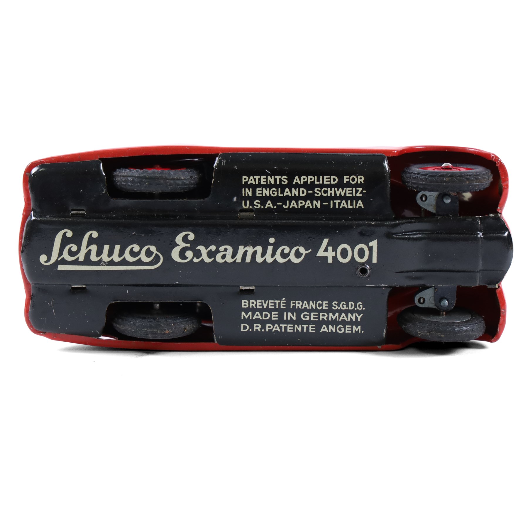 Schuco Examico 4001 tinplate clockwork car, in red with burgundy interior, with key and instructions, boxed