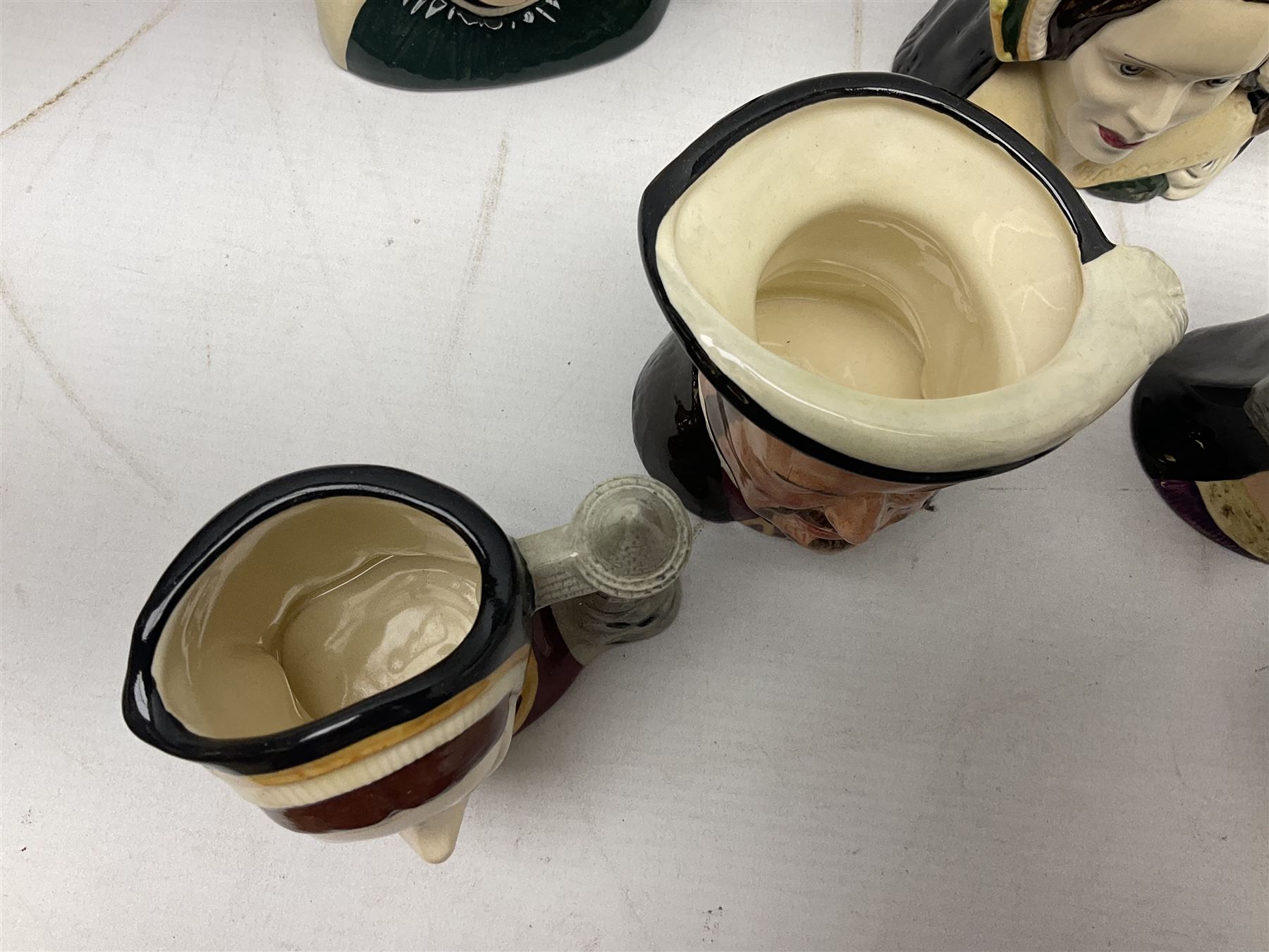 Royal Doulton Henry VIII and his Six Wives Character Jugs, comprising of Henry VIII D6647, Catherine of Aragon D6657, Anne Boleyn D6650, Jane Seymour D6746, Anne of Cleves D6753, Catherine Howard D6692 and Catherine Parr D6751, tallest H10cm