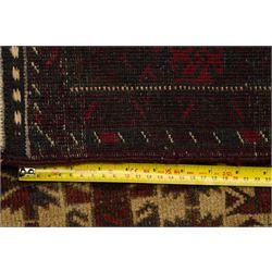 Two hand-knotted rugs, comprising Persian runner and Turkoman prayer rug, Persian hand-knotted runner, red and dark navy ground with four diamond medallions and geometric motifs, enclosed by multicoloured geometric border, striped kilim ends with fringes, H244cm, W58cm; Turkoman hand-knotted prayer rug, ivory mihrab field decorated with repeating stylised geometric motifs, enclosed by multiple geometric borders in madder red and brown, with fringed ends, H150cm, W93cm