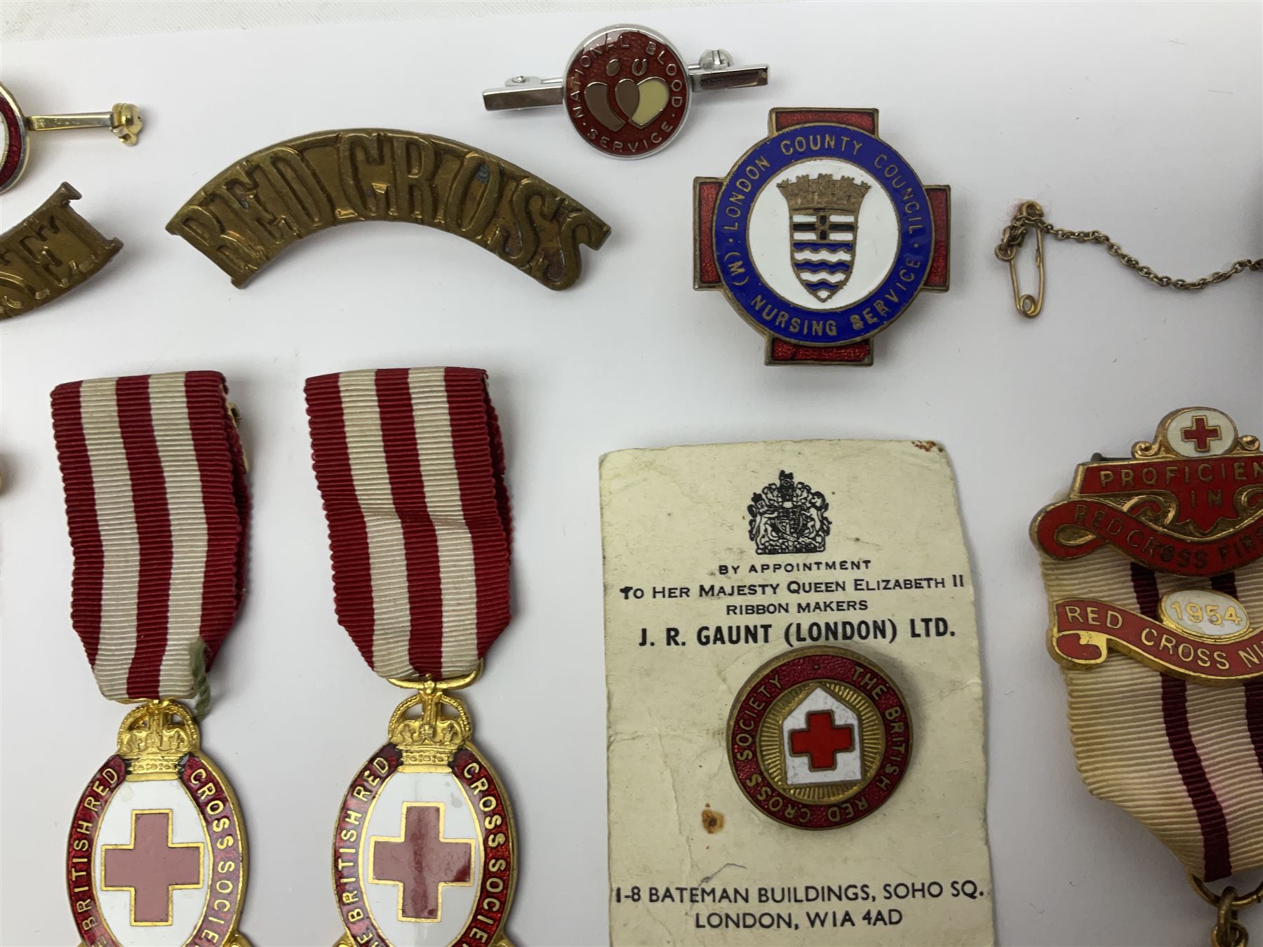 Collection of St John Ambulance enamel and metal badges, together with Red Cross medals and badges