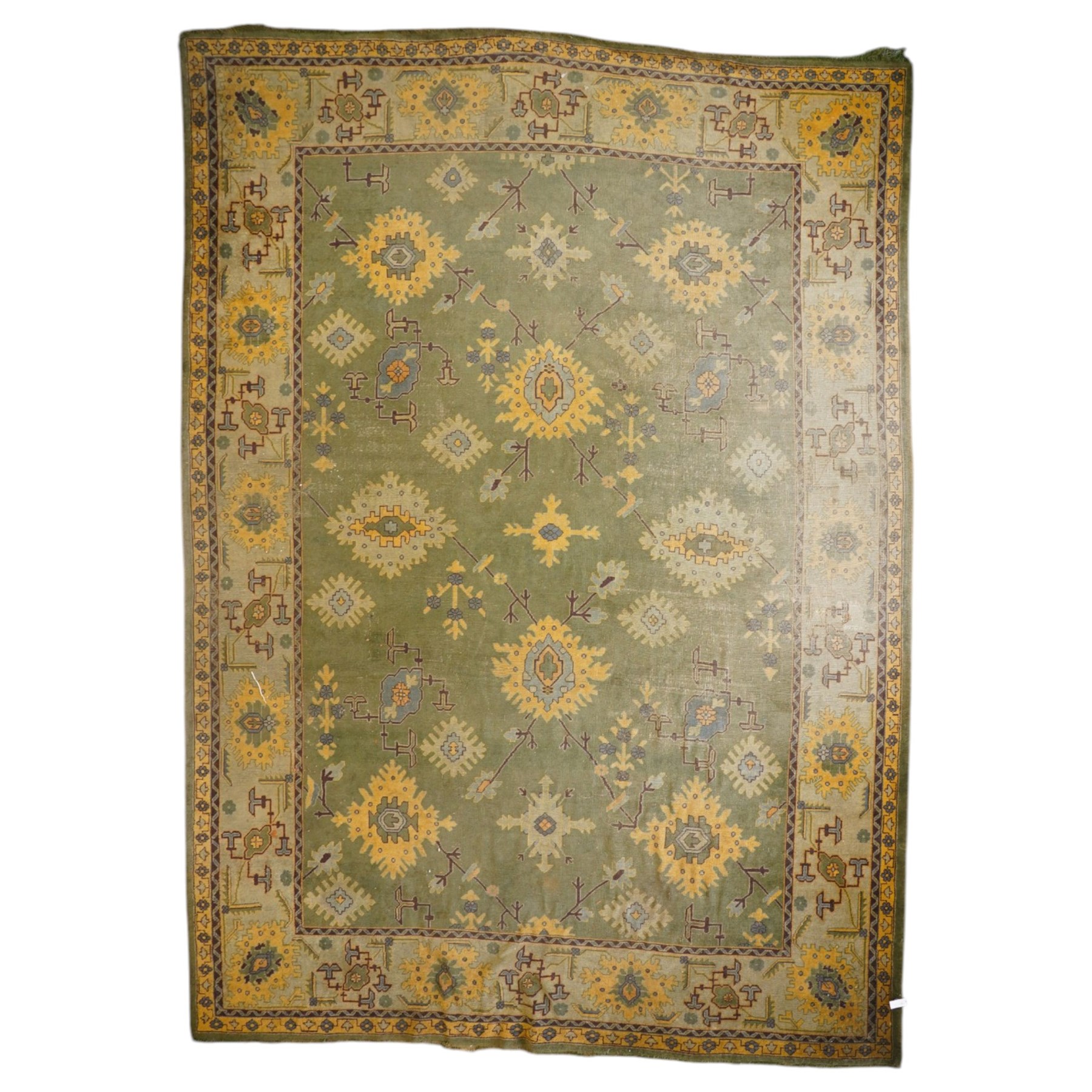 Lage Turkish Oushak green ground carpet, the field decorated with large stylised plant motifs and geometric design, the sage green guard band with further repeating foliate motifs