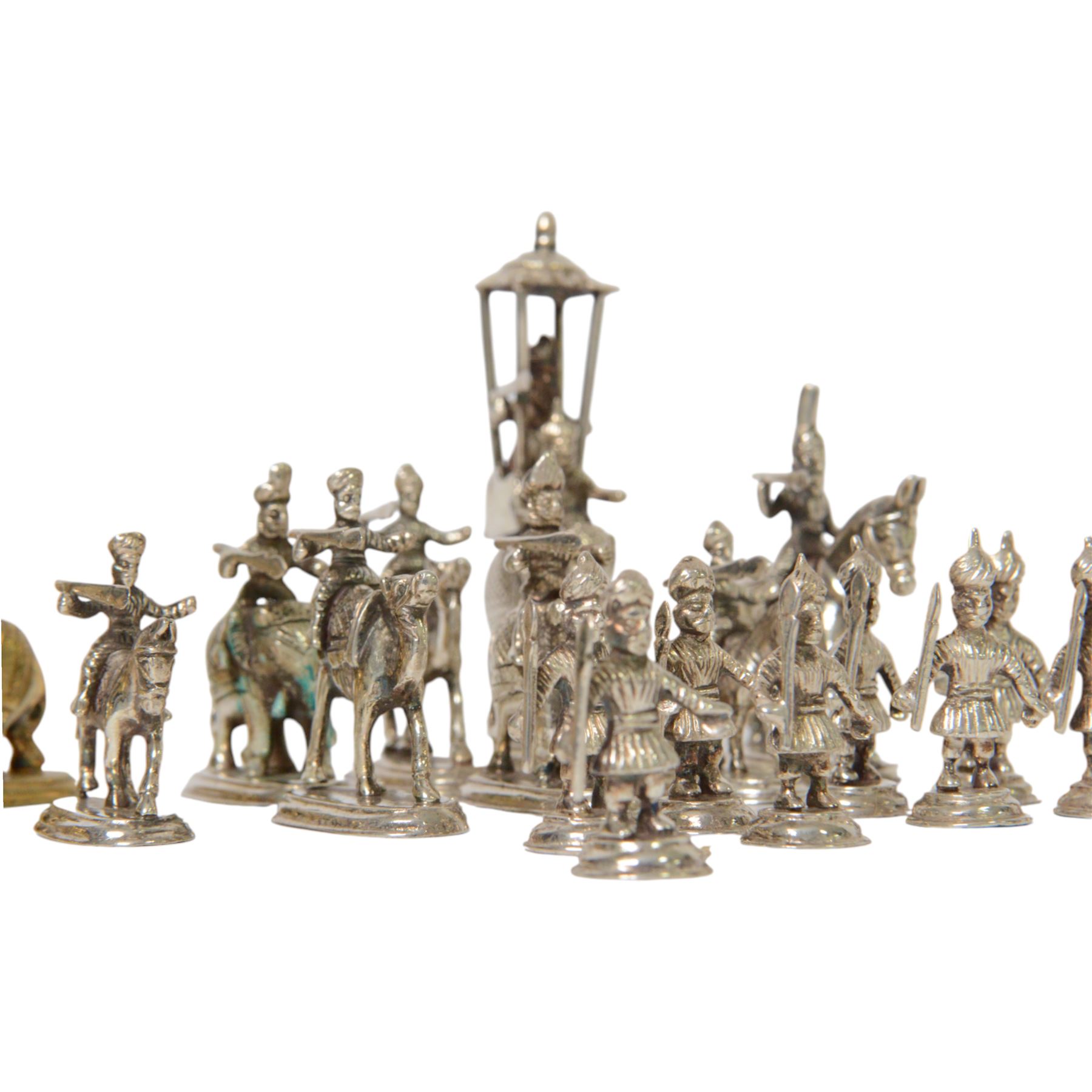 19th century Moghul Indian silver and silver gilt chess set, comprising thirty-two pieces, modelled as soldiers mounted upon elephants, camels and horses with the pawns on foot, unmarked, King H10cm