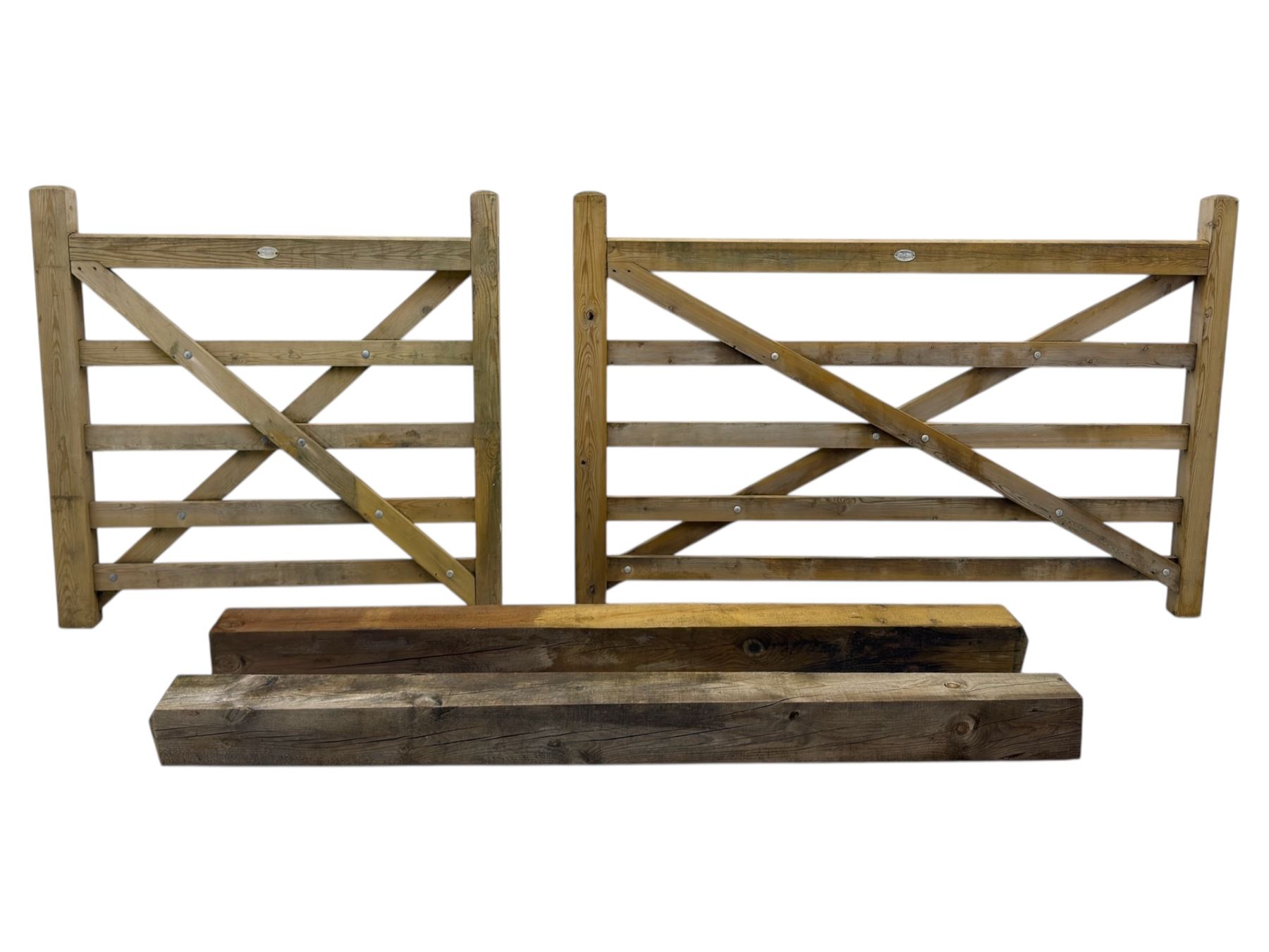 Two wooden gates with post hinges and latches