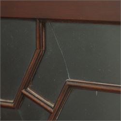 Early 20th century Chippendale design mahogany bookcase, projecting moulded cornice over four astragal glazed doors, the interior fitted with adjustable shelves, on bracket feet 