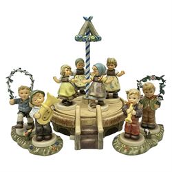 Hummel by Goebel, Sounds of Spring collectors set, eleven piece set comprising  turntable maypole stand, two smaller stands and eight figures, maypole stand H27