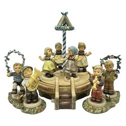  Hummel by Goebel, Sounds of Spring collectors set, eleven piece set comprising  turntable maypole stand, two smaller stands and eight figures, maypole stand H27