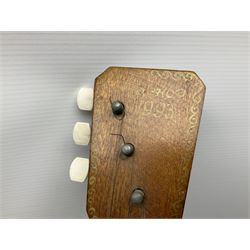 Russian balalaika with six-piece segmented back, the top painted with a scene of Russian onion capped buildings monogrammed K.B.H.1993; bears cyrillic label; L67.5cm; in carrying bag