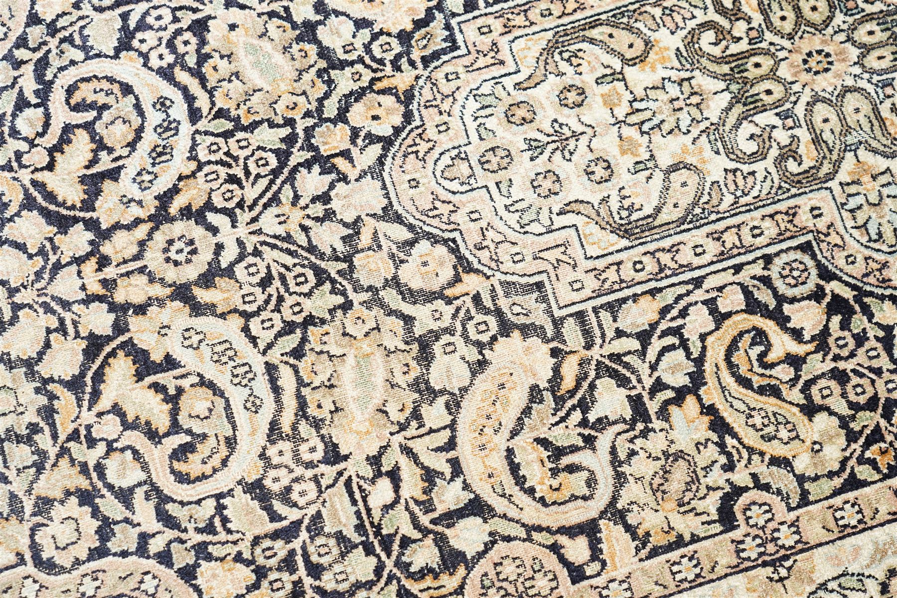 Persian style rug, central medallion with symmetrical floral arabesques, complex and layered borders featuring flowers and scrolling vinework