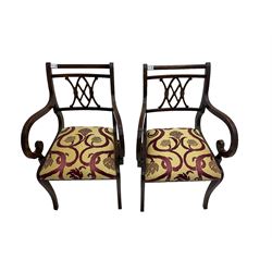 Regency design mahogany twin pedestal dining table, rectangular top with reeded edge, acanthus carved turned column terminating in reeded tripod base with hairy paw feet and castors (W172cm D92cm H75cm) and set eight (6+2) Regency design mahogany dining chairs, pierced back with scroll design, seat upholstered in patterned laurel green fabric, raised on reeded sabre supports (W48cm H88cm)