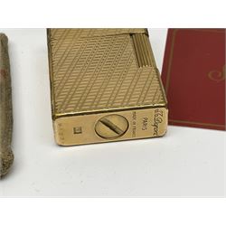 St Dupont gold plated cigarette lighter, with engine turned decoration, serial no EW1279, together with three powder compacts, including Stratton and Regent of London examples