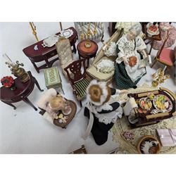 Dolls house living room and ding room furniture, including sofa, chair, long case clock, Christmas trees, fireplace, dresser, chairs, tables, mirrors, seven figures and a collection of predominantly Christmas themed decorations, food, etc