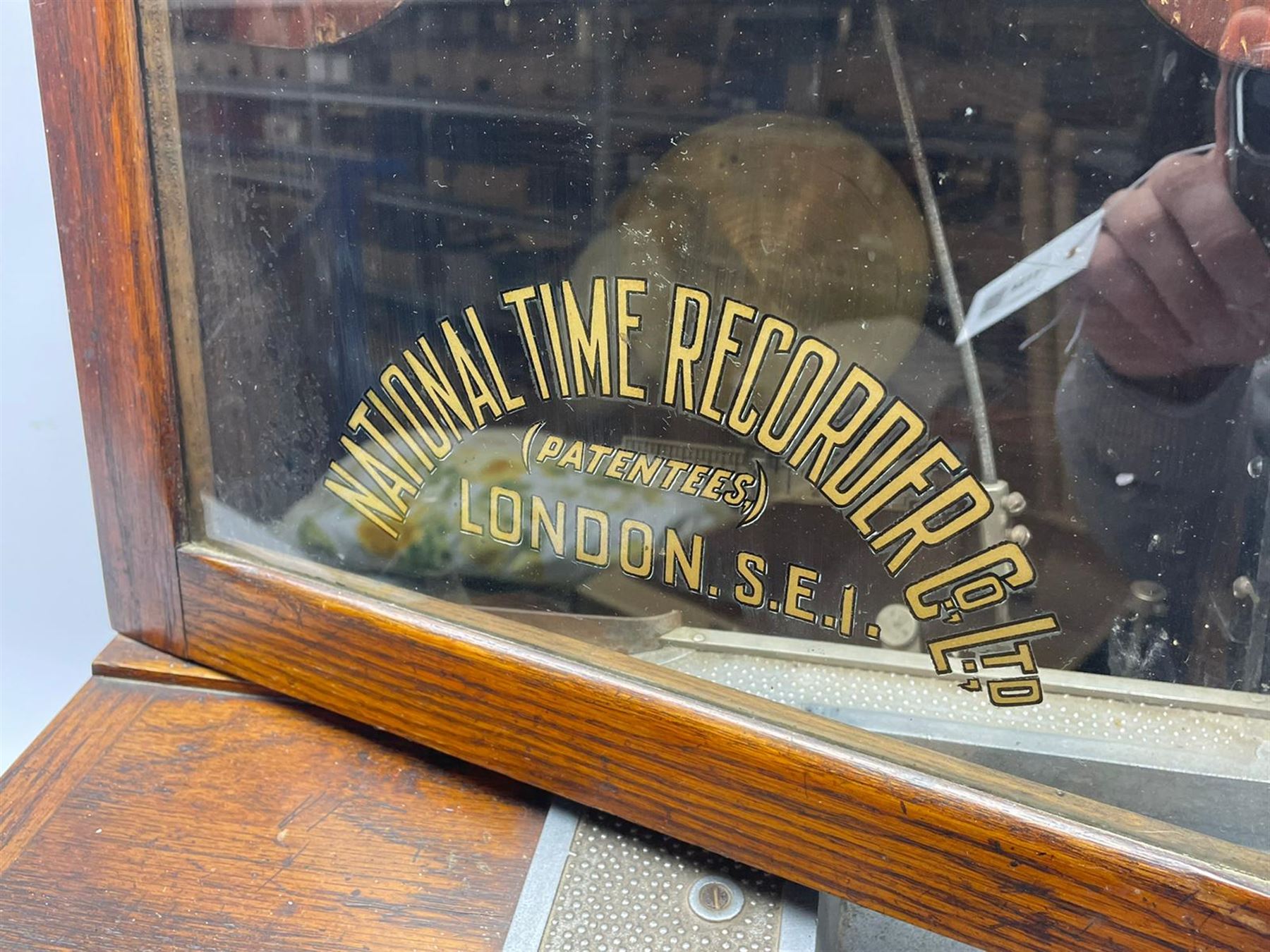 Early 20th century oak cased time recorder, circular Roman dial signed 'Time Recorders Leeds Ltd. Park Lane & Oxford Row Leeds', the glazed door signed 'National Time Recorder Co Ltd. London...'