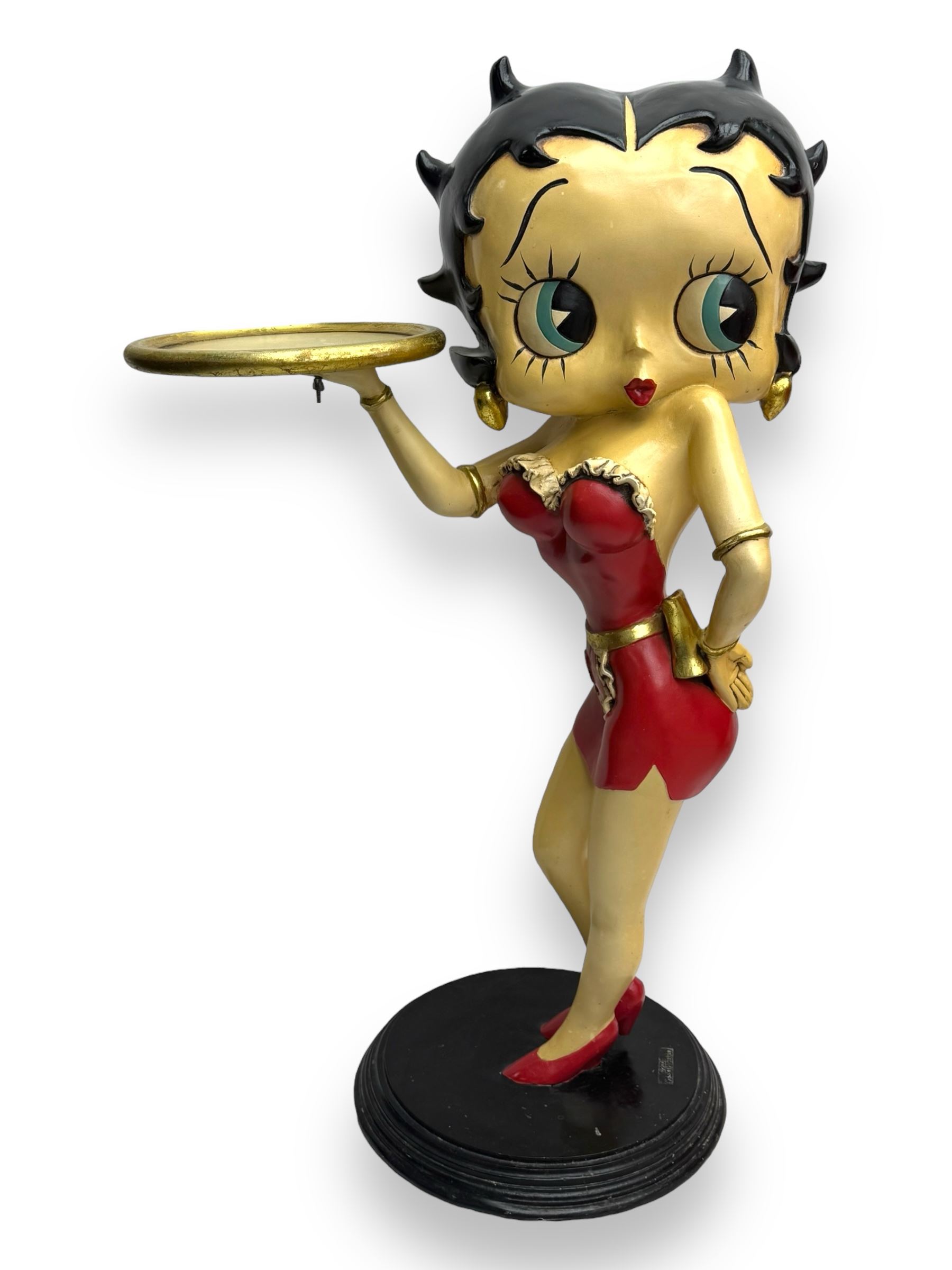 Contemporary Betty Boop waitress figure, modelled standing with one hand holding a circular tray, dressed in a red dress with gold accents, on a black circular base
