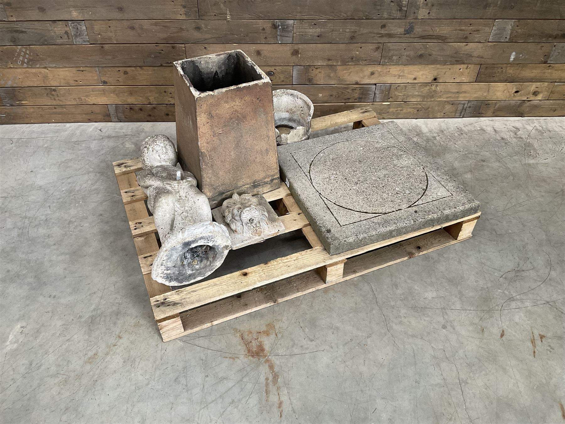 Collection of three Victorian and early 20th century reclaimed terracotta chimney pots, comprising: one cylindrical form with weathered, cracked glaze and flared octagonal base; one deep red cylindrical pot with fluted midsection and castellated rim, bearing moulded number ‘25’; and one tapering hexagonal example with wide flared rim and weathered patina. All with age-related wear and chips, consistent with use and outdoor exposure. Plus a selection of cast stone pieces including fountain 
